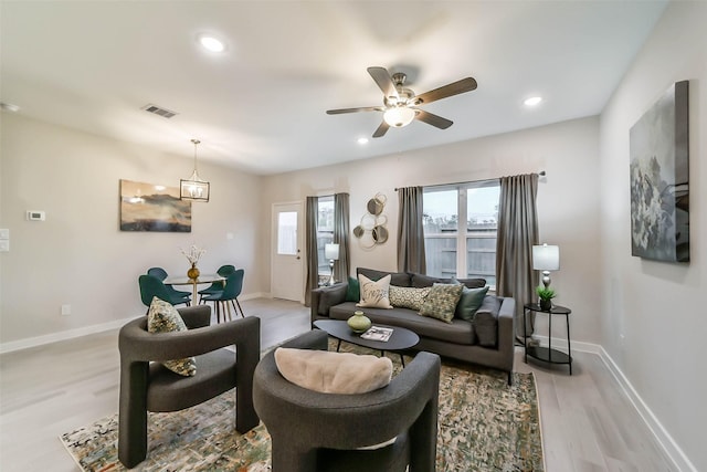 living room featuring light wood-type flooring and ceiling fan