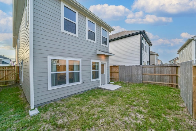 rear view of property with a yard