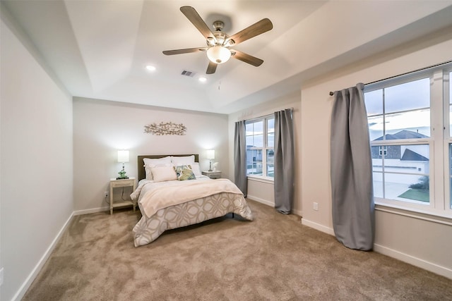 bedroom with multiple windows, ceiling fan, and carpet floors