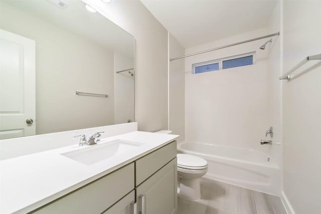 full bathroom with vanity, hardwood / wood-style flooring, toilet, and shower / washtub combination