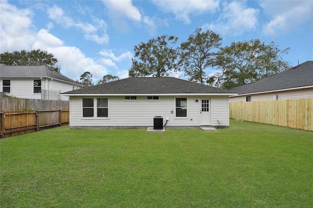 back of house featuring central AC and a lawn