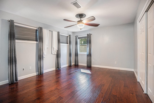 unfurnished bedroom featuring ceiling fan and dark wood-type flooring