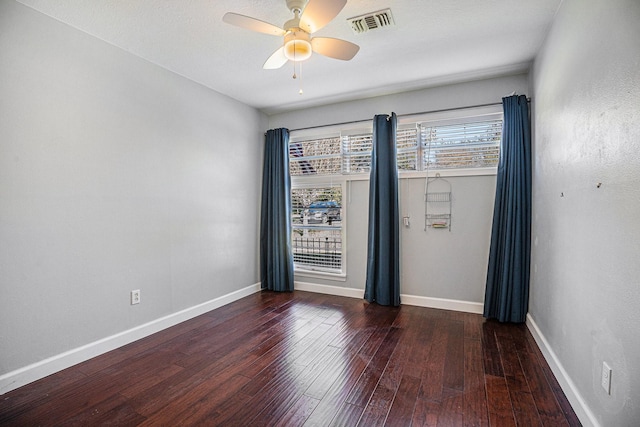 unfurnished room with ceiling fan and dark hardwood / wood-style floors