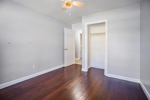 unfurnished bedroom featuring ceiling fan, a closet, and dark hardwood / wood-style floors