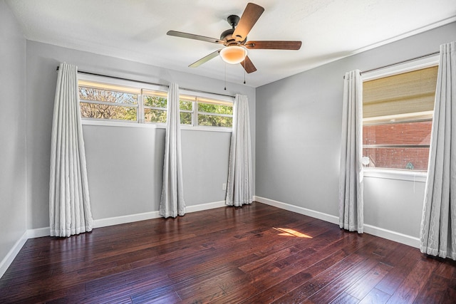 unfurnished room with ceiling fan and dark wood-type flooring