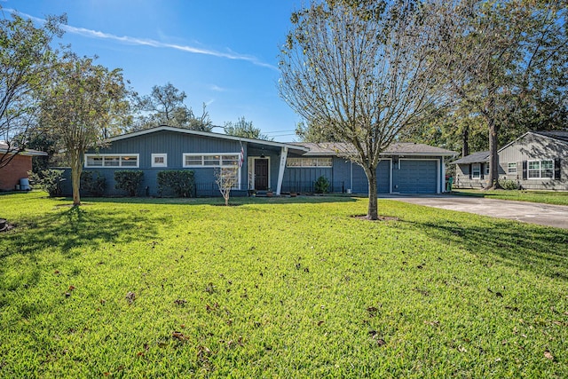 ranch-style house with a garage and a front lawn