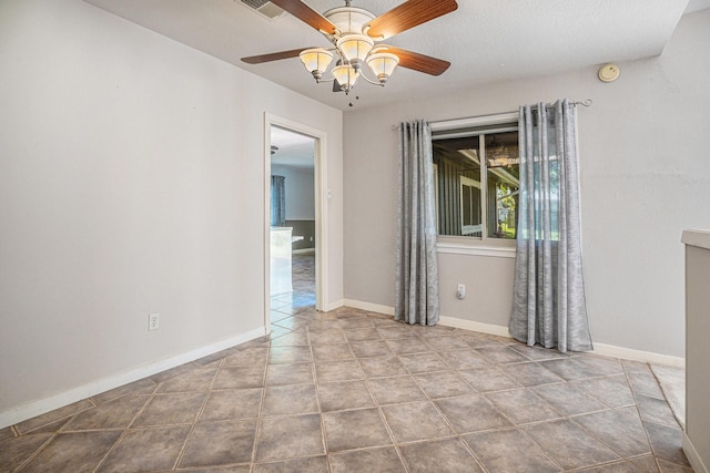 tiled spare room with ceiling fan