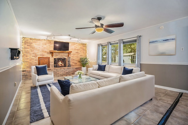 tiled living room with a brick fireplace, ceiling fan, ornamental molding, and brick wall