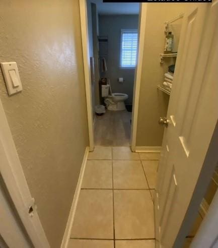 bathroom with tile patterned flooring and toilet