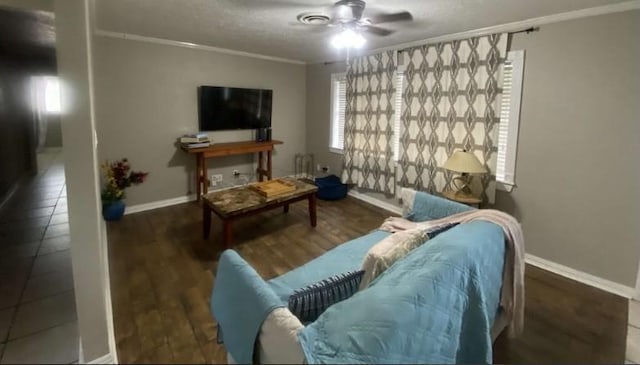 tiled living room featuring ceiling fan and ornamental molding