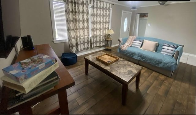 living room with dark hardwood / wood-style flooring and crown molding