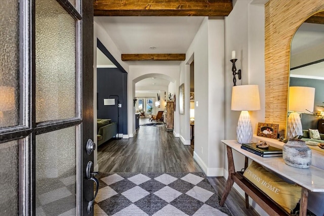 corridor featuring beam ceiling and dark hardwood / wood-style floors