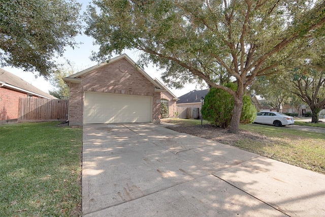 view of front of house featuring a front yard and a garage