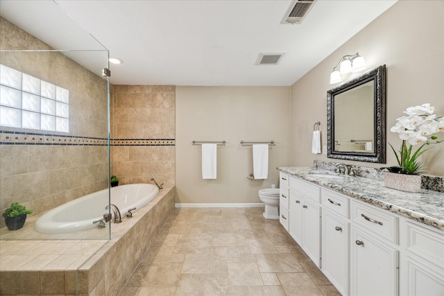 bathroom featuring vanity, toilet, and tiled tub