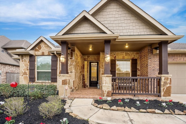6615 Cottonwood Crest Ln, Katy, TX 77493 - property entrance with covered porch, an attached garage, and stone siding