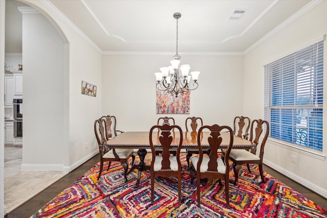 dining room featuring ornamental molding and a chandelier