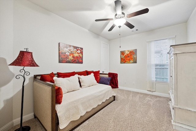 bedroom featuring light carpet and ceiling fan