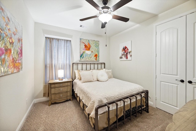 carpeted bedroom with ceiling fan and a closet