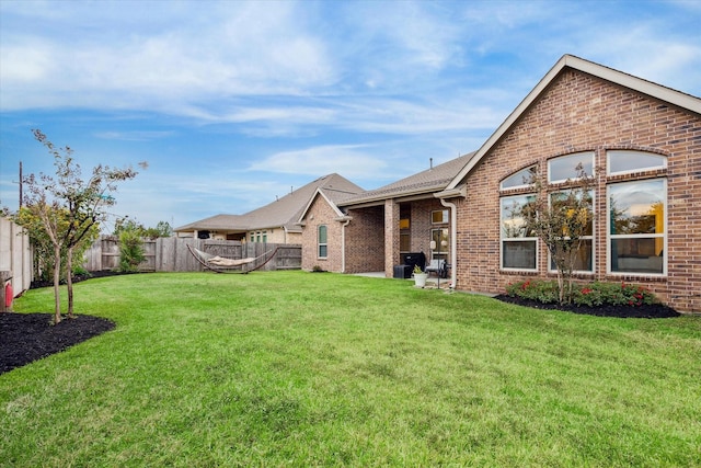 rear view of house featuring a lawn