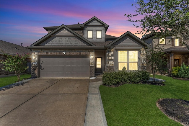 view of front of property featuring a lawn and a garage