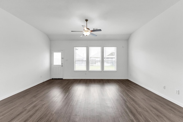 empty room with ceiling fan, dark hardwood / wood-style flooring, and lofted ceiling