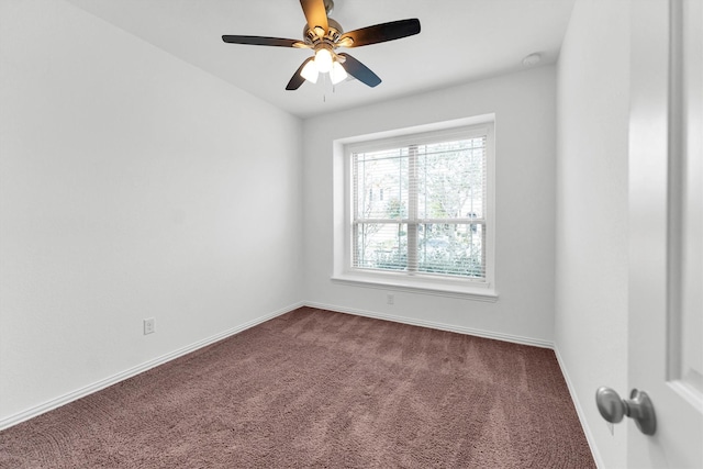 carpeted spare room featuring ceiling fan