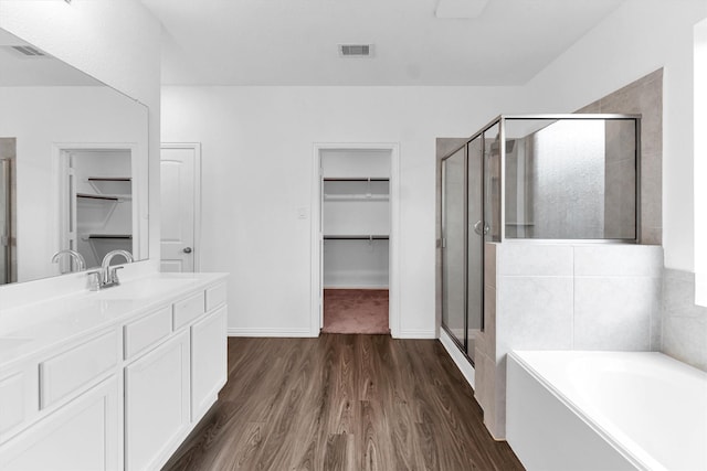 bathroom with vanity, separate shower and tub, and wood-type flooring