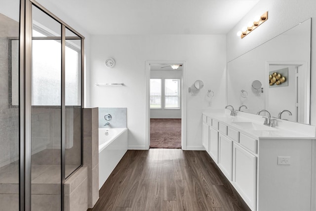 bathroom with wood-type flooring, vanity, shower with separate bathtub, and ceiling fan