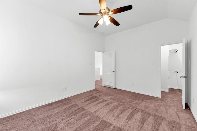 unfurnished bedroom featuring ceiling fan, light colored carpet, and vaulted ceiling