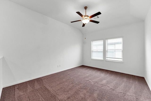 carpeted spare room with ceiling fan and lofted ceiling