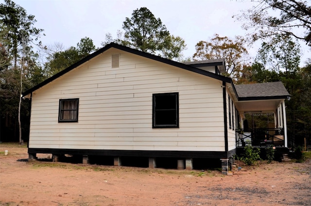 view of side of property with a porch