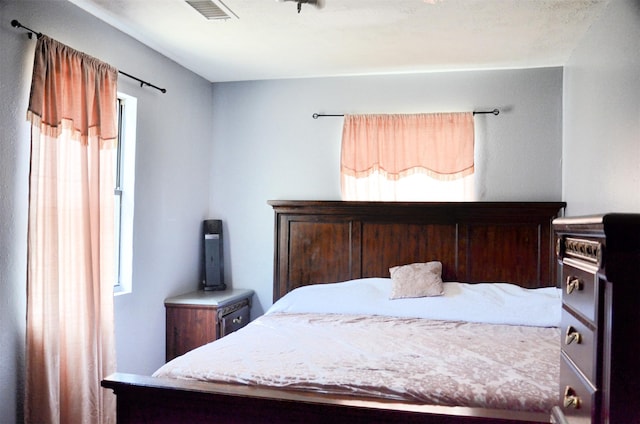 bedroom with multiple windows