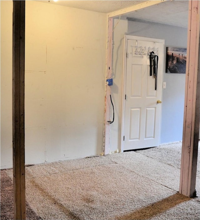 carpeted empty room with a textured ceiling