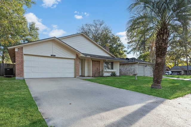 ranch-style house with a garage, central air condition unit, and a front lawn