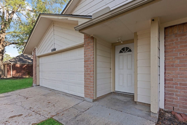 view of exterior entry featuring a garage