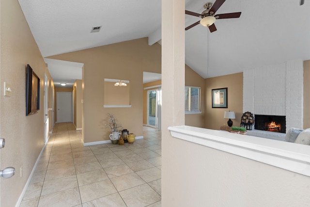 corridor with light tile patterned flooring and vaulted ceiling with beams