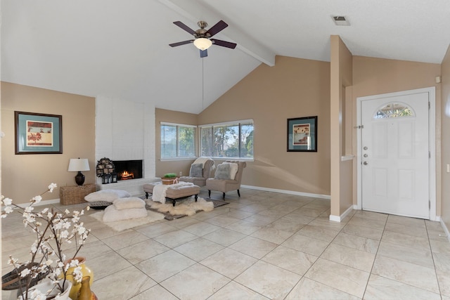 living room with ceiling fan, light tile patterned floors, lofted ceiling with beams, and a brick fireplace