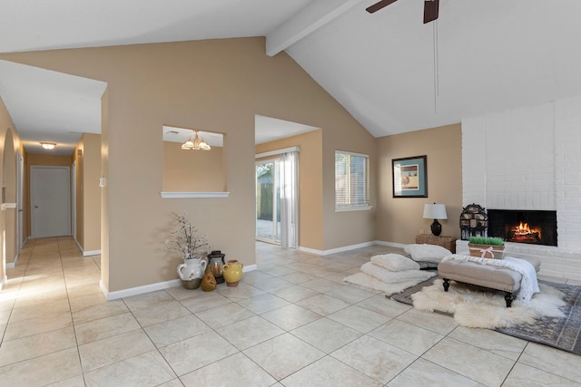 living room with ceiling fan with notable chandelier, beam ceiling, light tile patterned floors, and a fireplace