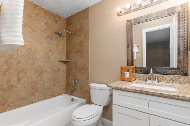 full bathroom with vanity, toilet, a textured ceiling, and tiled shower / bath