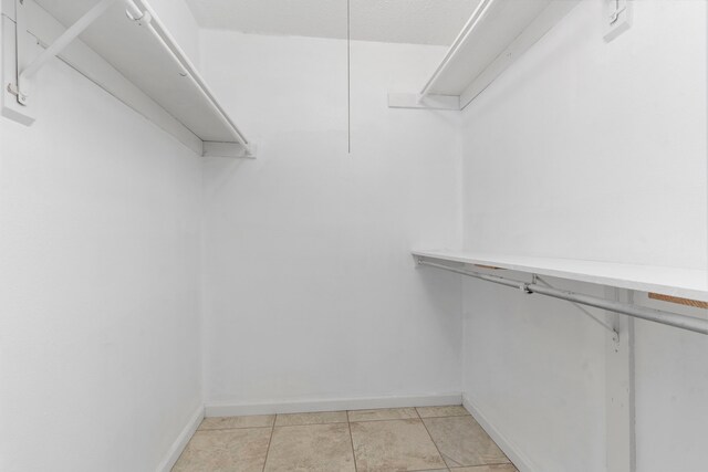 spacious closet with light tile patterned flooring