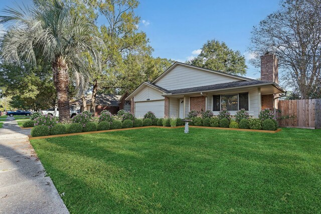 view of front facade with a garage and a front lawn