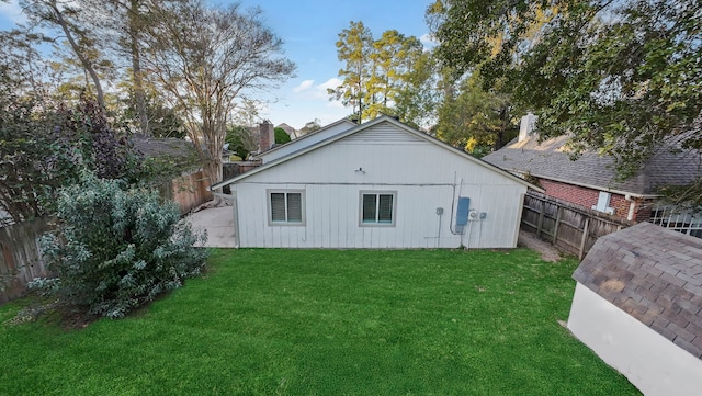 back of property featuring a yard