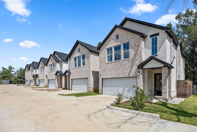 7934 Hennessy Ln Unit 2, Spring, TX 77389 - view of front of house with a garage, brick siding, driveway, and a residential view