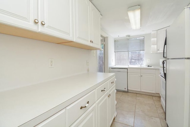 kitchen featuring white appliances and white cabinetry