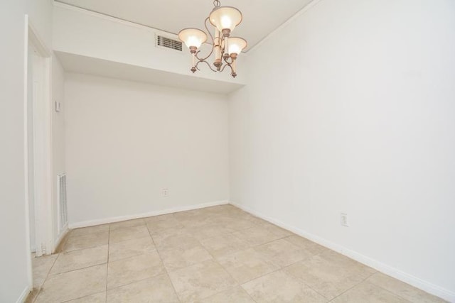 tiled spare room featuring a notable chandelier