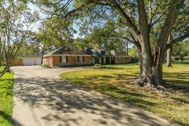 ranch-style house featuring a front yard and an outbuilding