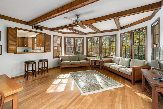 sunroom with beamed ceiling and ceiling fan