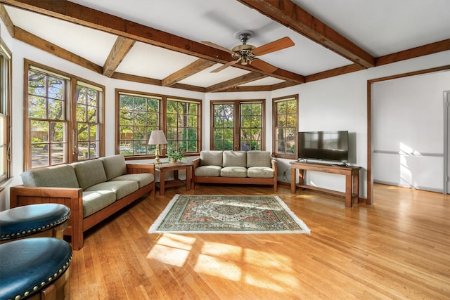 sunroom / solarium featuring ceiling fan, french doors, and beamed ceiling