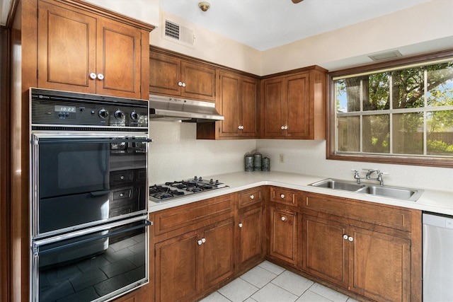 kitchen featuring light tile patterned flooring, sink, and stainless steel appliances