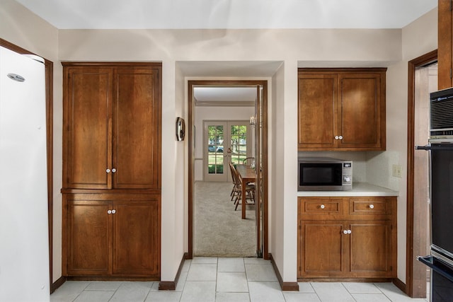 kitchen with light carpet, appliances with stainless steel finishes, and french doors